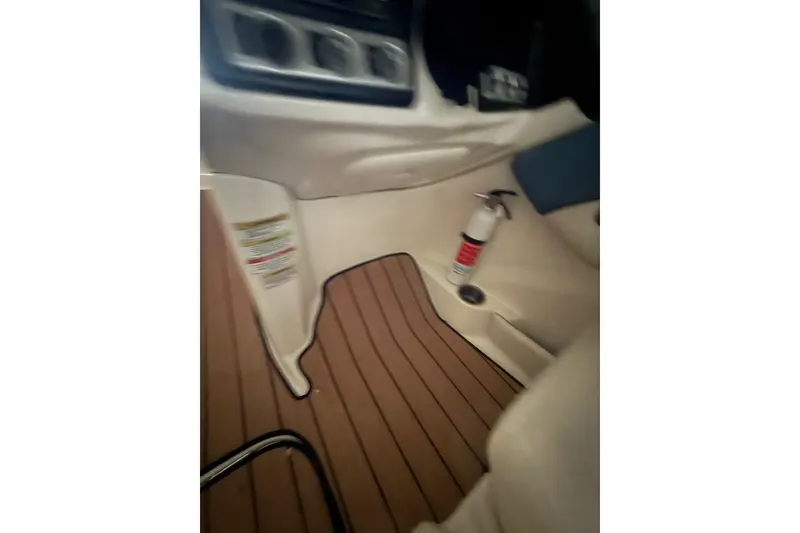 Slide: The Image of Interior of 2012 Bayliner 235 Bowrider with wood flooring and fire extinguisher. - 46