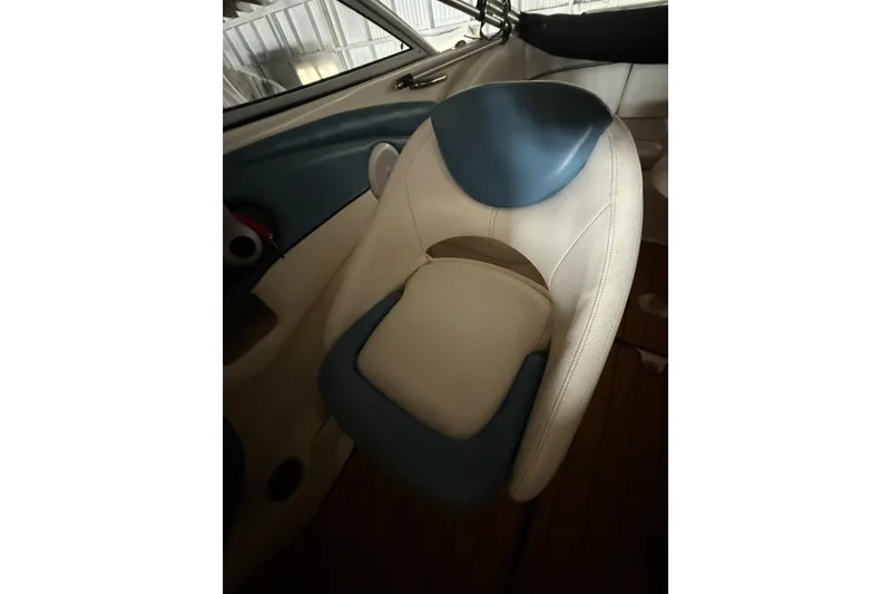 Slide: The Image of 2012 Bayliner 235 Bowrider interior seat with blue and white upholstery. - 47