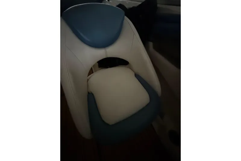 Slide: The Image of 2012 Bayliner 235 Bowrider boat seat with blue and white upholstery. - 48
