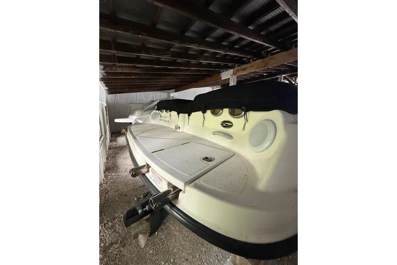 Slide: The Image of 2012 Bayliner 235 Bowrider stored in a covered area, rear view. - 8