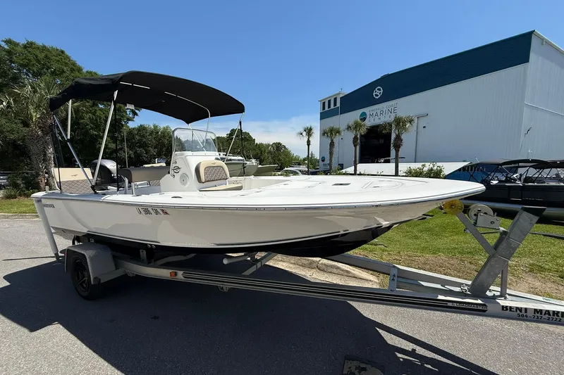 The Image of 2021 Tidewater 1910 Bay Max boat on trailer at marine center, sunny day. - 0