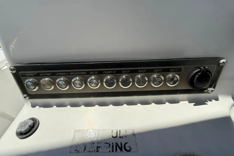 Slide: The Image of Control panel of a 2021 Tidewater 1910 Bay Max boat with labeled switches. - 14