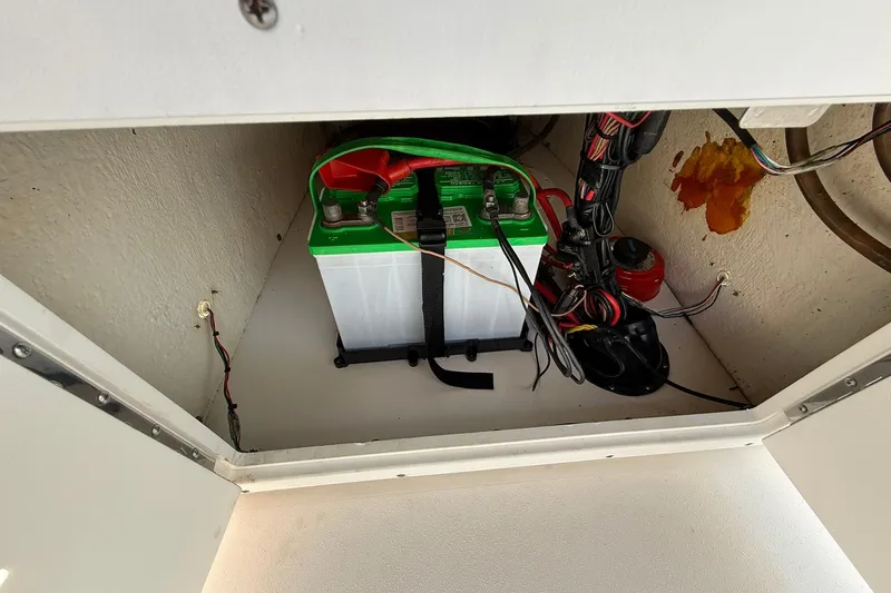 Slide: The Image of Battery compartment of a 2021 Tidewater 1910 Bay Max boat, featuring wiring and connections. - 16