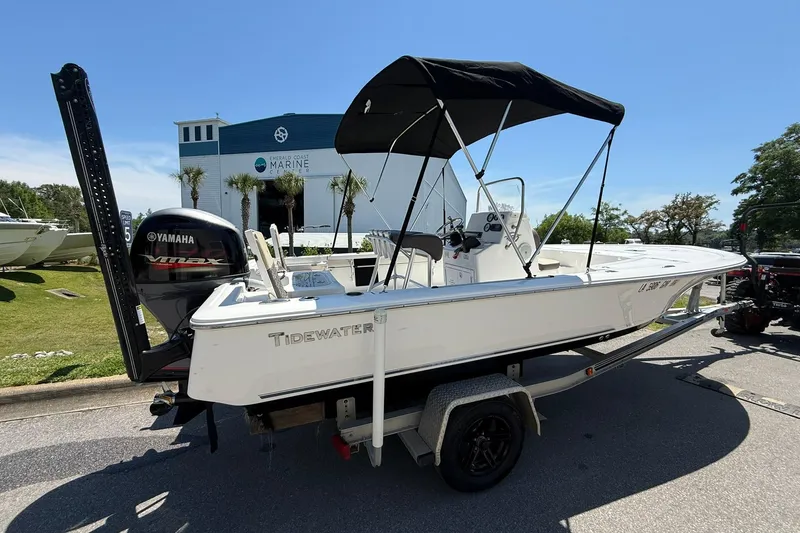 Slide: The Image of 2021 Tidewater 1910 Bay Max boat with Yamaha engine, parked outside marine dealership. - 2