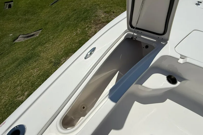 Slide: The Image of 2021 Tidewater 1910 Bay Max boat storage compartment open on grassy background. - 6