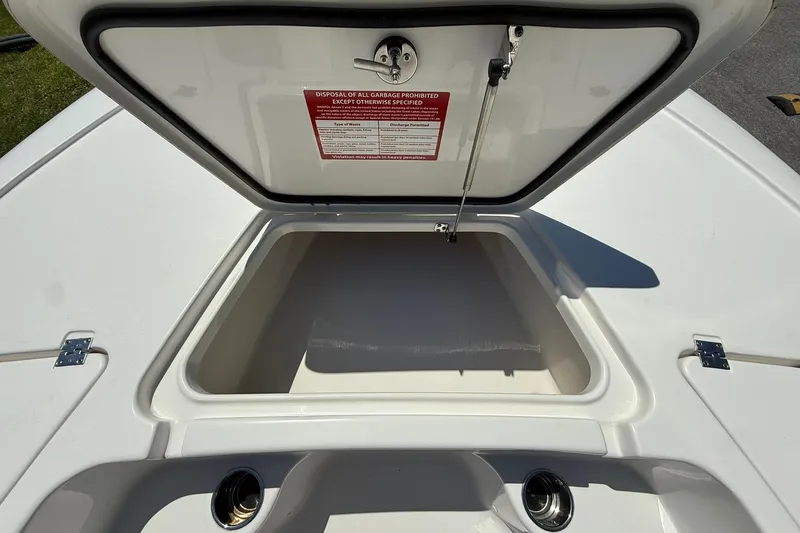 Slide: The Image of Open storage compartment on a 2021 Tidewater 1910 Bay Max boat, featuring a warning label. - 7
