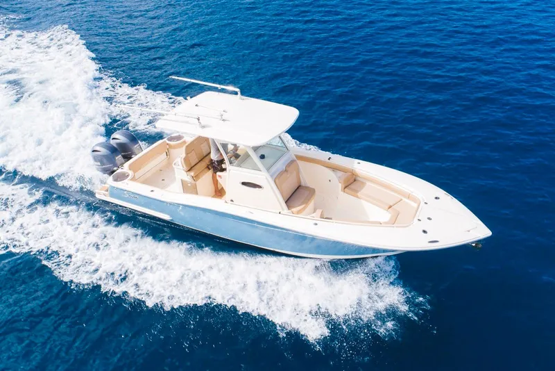 Slide: The Image of 2019 Scout 275 LXF boat cruising on clear blue ocean waters. - 1