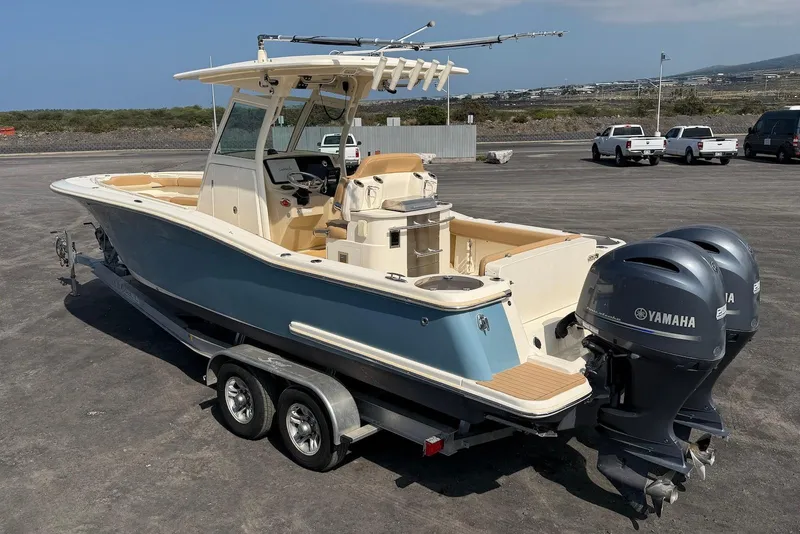 Slide: The Image of 2019 Scout 275 LXF boat with dual Yamaha engines on a trailer. - 13