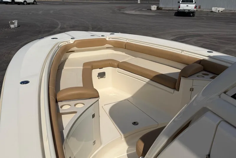 Slide: The Image of 2019 Scout 275 LXF boat interior with tan seating and cup holders. - 15