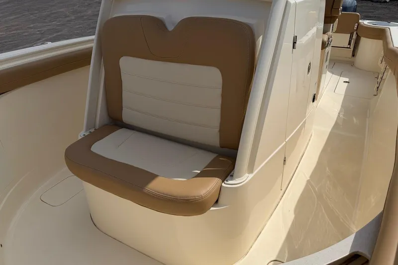 Slide: The Image of 2019 Scout 275 LXF boat interior with tan and white seating. - 17