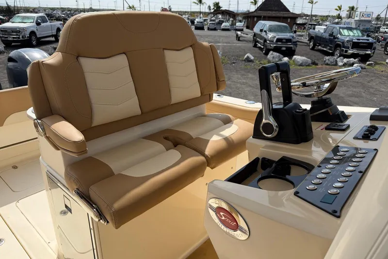 Slide: The Image of 2019 Scout 275 LXF boat interior with tan seating and control panel. - 18
