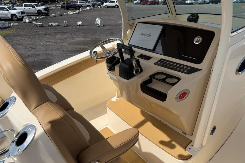 Slide: The Image of 2019 Scout 275 LXF boat cockpit with Garmin navigation system and beige seating. - 19