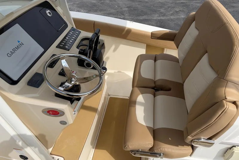 Slide: The Image of 2019 Scout 275 LXF boat cockpit with Garmin display and beige seating. - 20