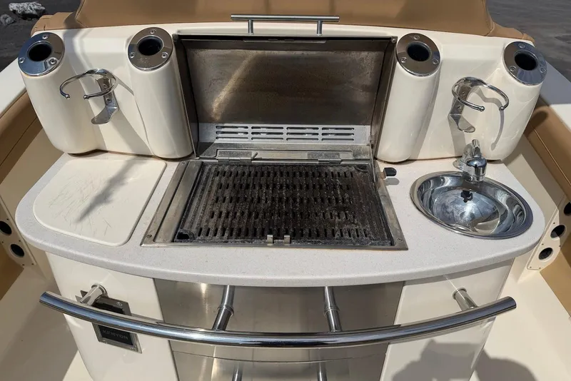 Slide: The Image of Outdoor grill and sink setup on a 2019 Scout 275 LXF boat. - 24