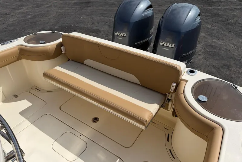 Slide: The Image of 2019 Scout 275 LXF boat interior with tan seating and dual Yamaha 200 engines. - 26