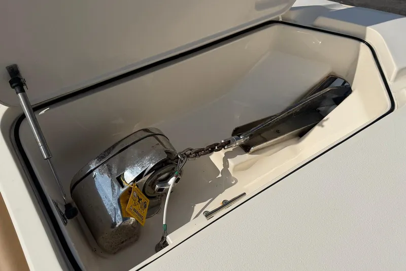 Slide: The Image of Anchor compartment of 2019 Scout 275 LXF boat, featuring a secured anchor and chain. - 27