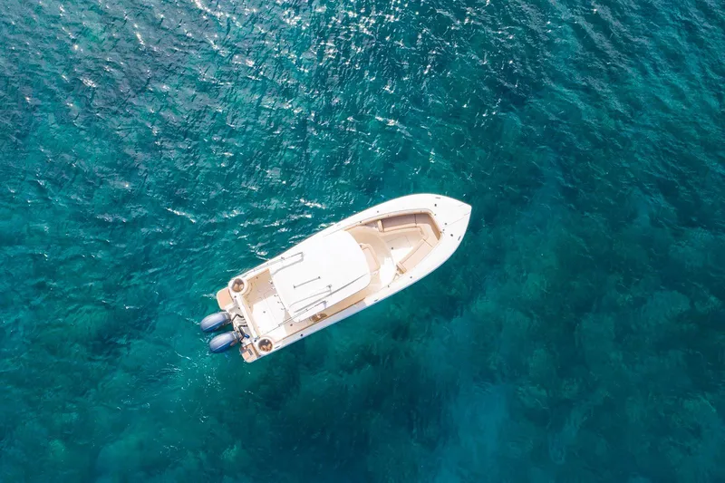 Slide: The Image of Aerial view of 2019 Scout 275 LXF boat on clear blue water. - 5
