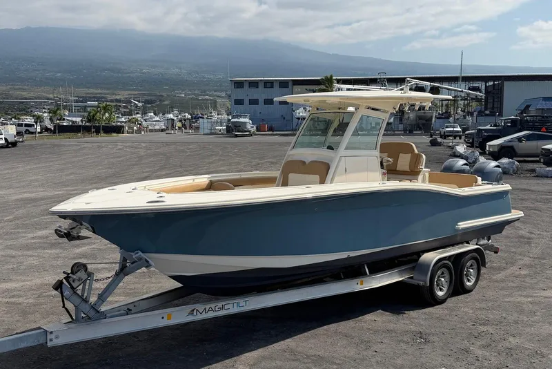 Slide: The Image of 2019 Scout 275 LXF boat on trailer in marina setting. - 6