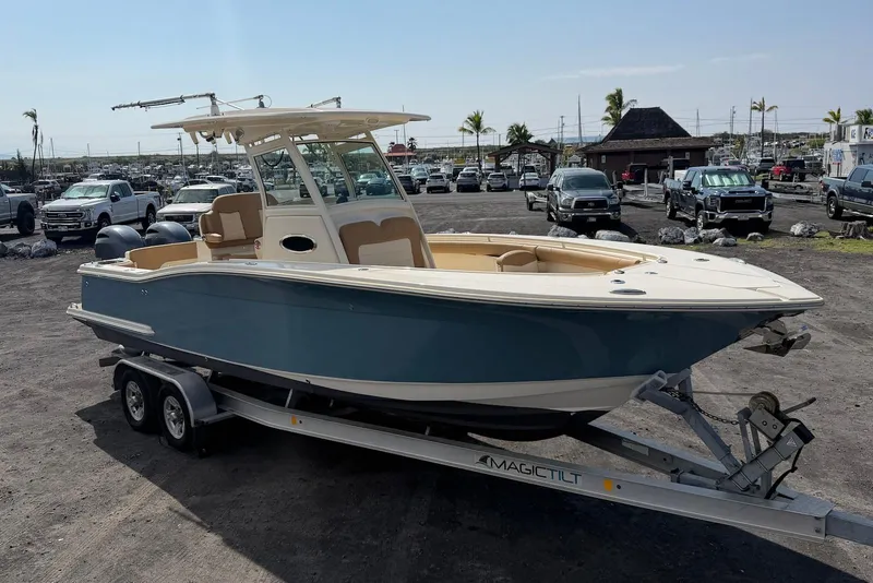 Slide: The Image of 2019 Scout 275 LXF boat on trailer in parking lot, sunny day. - 9