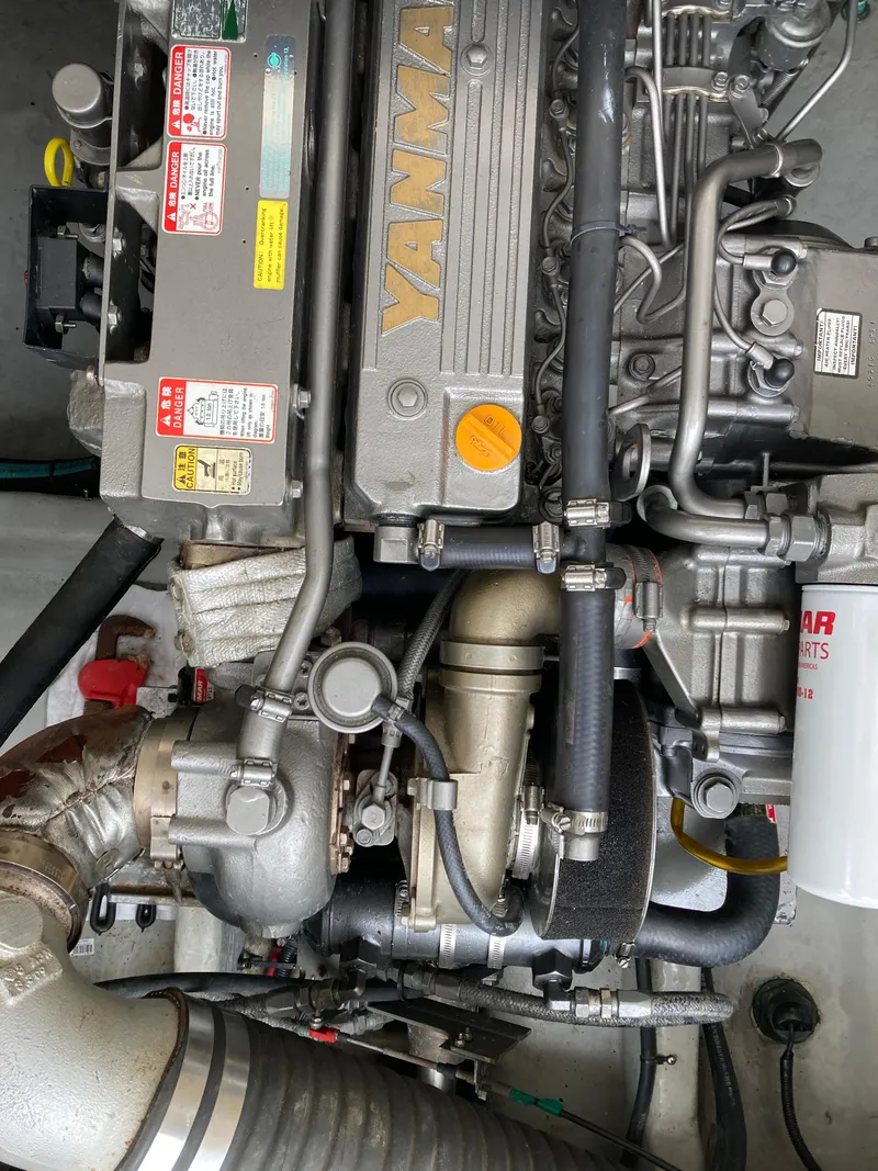 Slide: The Image of Engine of a 2004 Mainship Pilot 34 boat, featuring Yanmar components. - 52