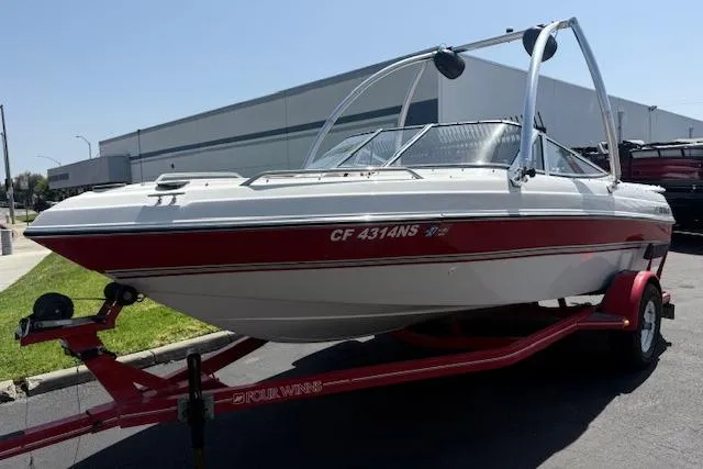 Slide: The Image of 1996 Four Winns 190 Horizon boat on red trailer, parked outdoors. - 1