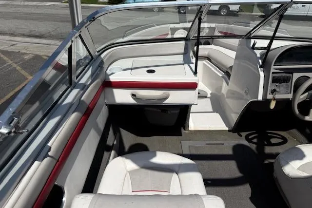 Slide: The Image of Interior of a 1996 Four Winns 190 Horizon boat with white and red seating. - 10