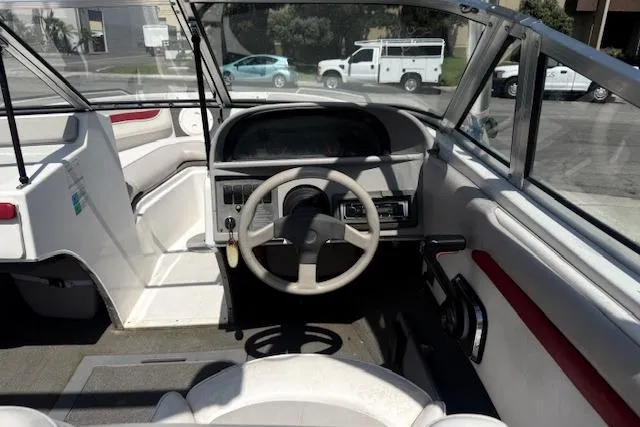 Slide: The Image of Interior of a 1996 Four Winns 190 Horizon boat, featuring steering wheel and dashboard. - 12