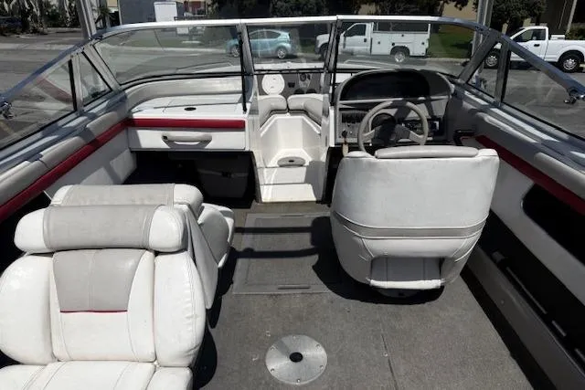 Slide: The Image of 1996 Four Winns 190 Horizon boat interior with white seating and steering wheel. - 13