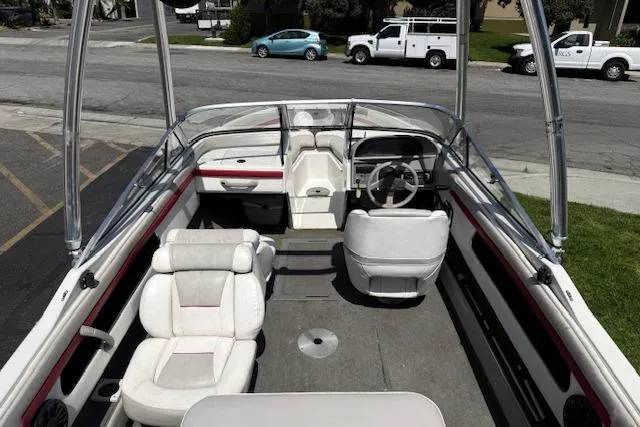 Slide: The Image of 1996 Four Winns 190 Horizon boat interior with white seating and steering wheel. - 14