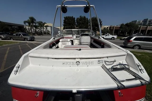 Slide: The Image of 1996 Four Winns 190 Horizon boat with white interior and red exterior, parked outdoors. - 15