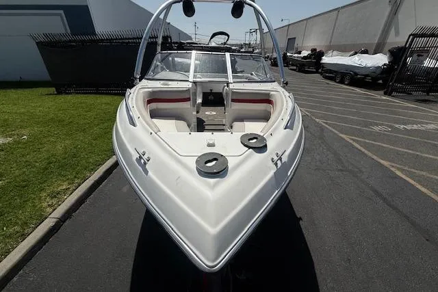Slide: The Image of 1996 Four Winns 190 Horizon boat, white exterior, parked outdoors on pavement. - 16