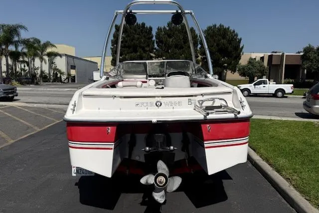 Slide: The Image of 1996 Four Winns 190 Horizon boat, rear view, parked outdoors on a sunny day. - 6