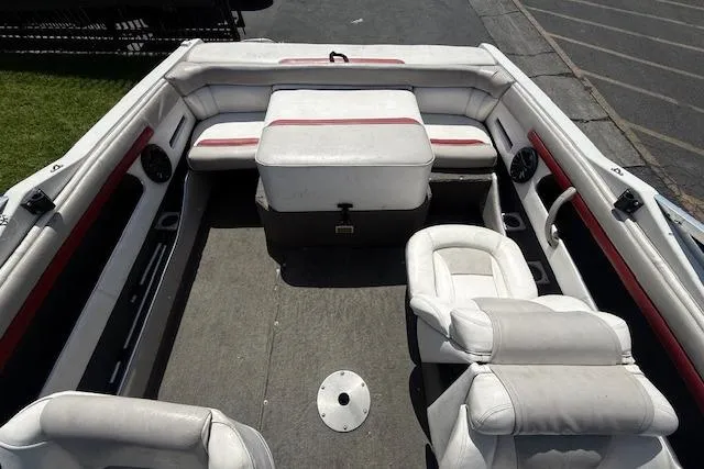 Slide: The Image of Interior of a 1996 Four Winns 190 Horizon boat with white seating and red accents. - 8
