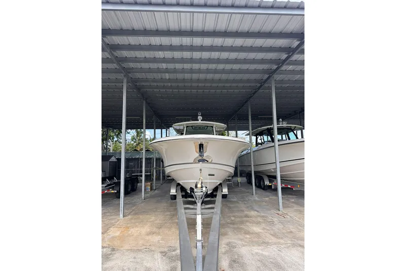 The Image of 2019 Boston Whaler 380 Outrage boat stored under a metal canopy. - 1