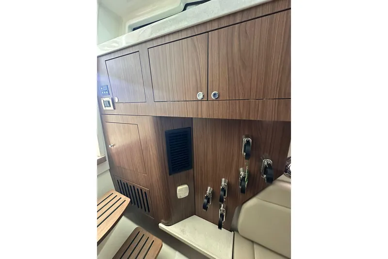 Slide: The Image of Interior view of 2019 Boston Whaler 380 Outrage, featuring wooden cabinetry and seating. - 12