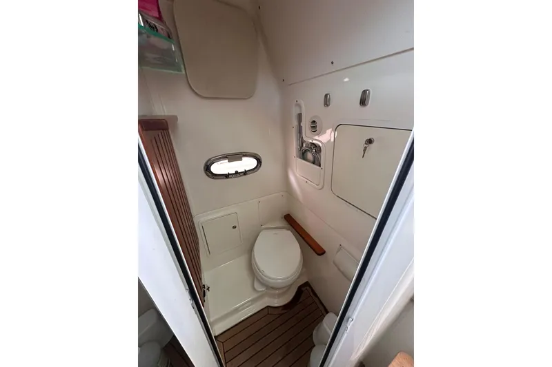 Slide: The Image of Interior of 2019 Boston Whaler 380 Outrage boat bathroom with wooden flooring. - 14