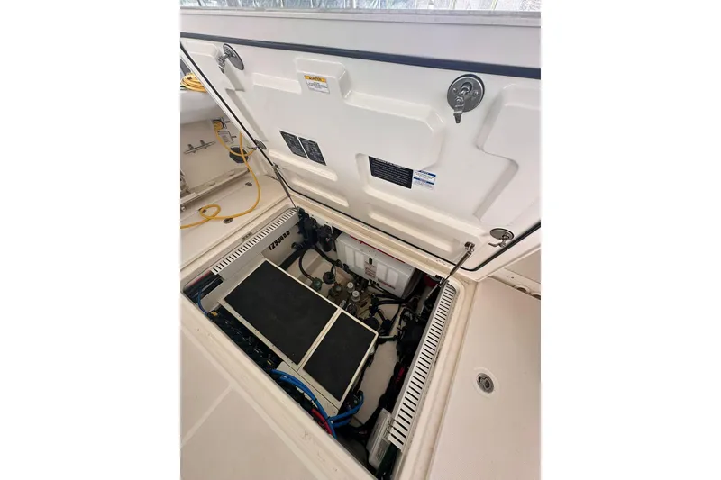 Slide: The Image of Open hatch of 2019 Boston Whaler 380 Outrage showing engine compartment details. - 18
