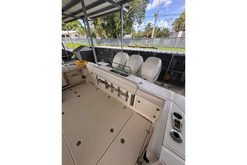 Slide: The Image of 2019 Boston Whaler 380 Outrage boat interior with triple outboard engines. - 3
