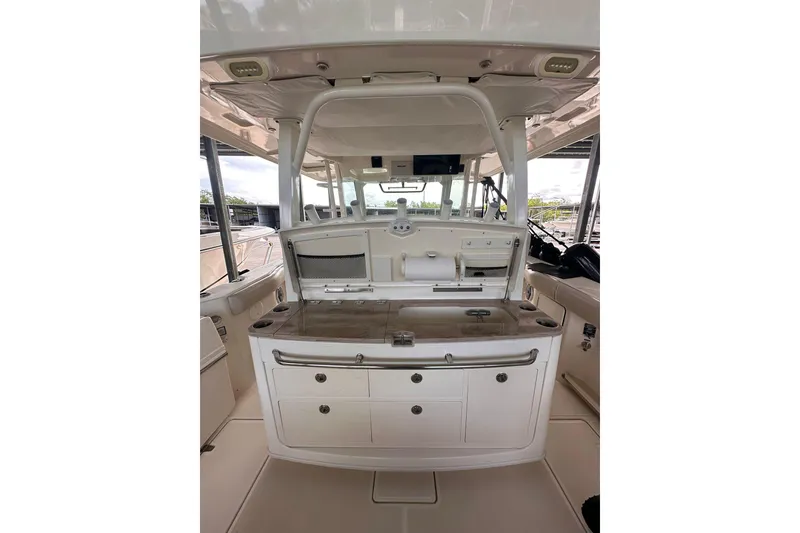 Slide: The Image of 2019 Boston Whaler 380 Outrage interior with helm station and storage compartments. - 5