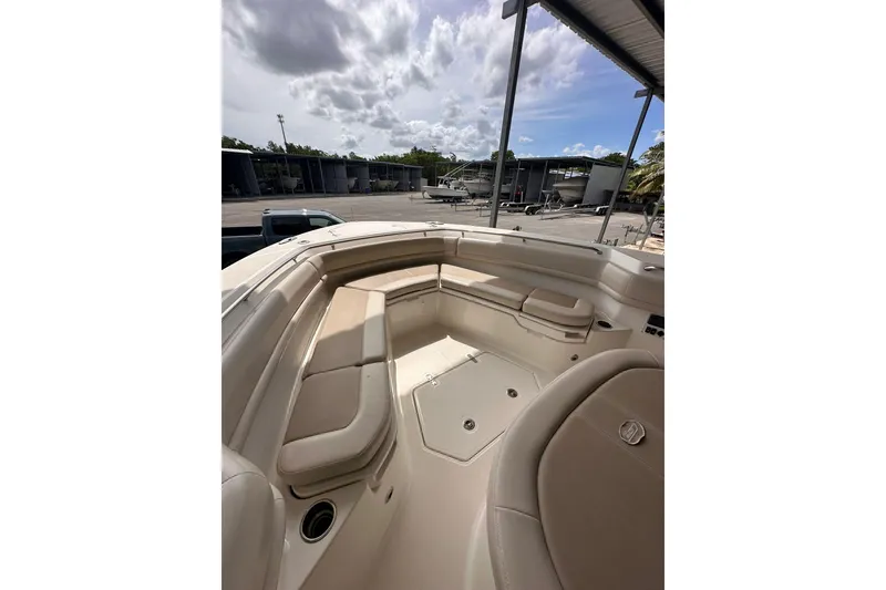 Slide: The Image of 2019 Boston Whaler 380 Outrage boat interior with cushioned seating and storage compartments. - 8