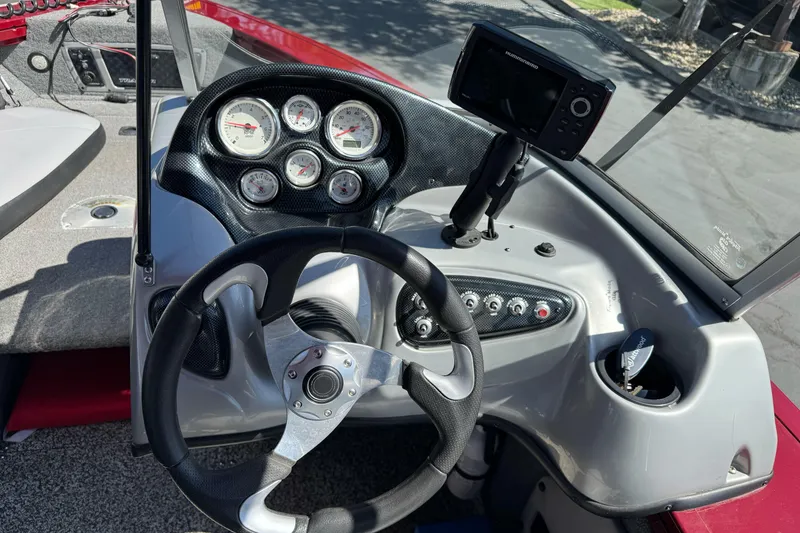 Slide: The Image of Steering console of 2015 Tracker Targa V-18 Combo boat with gauges and controls. - 13