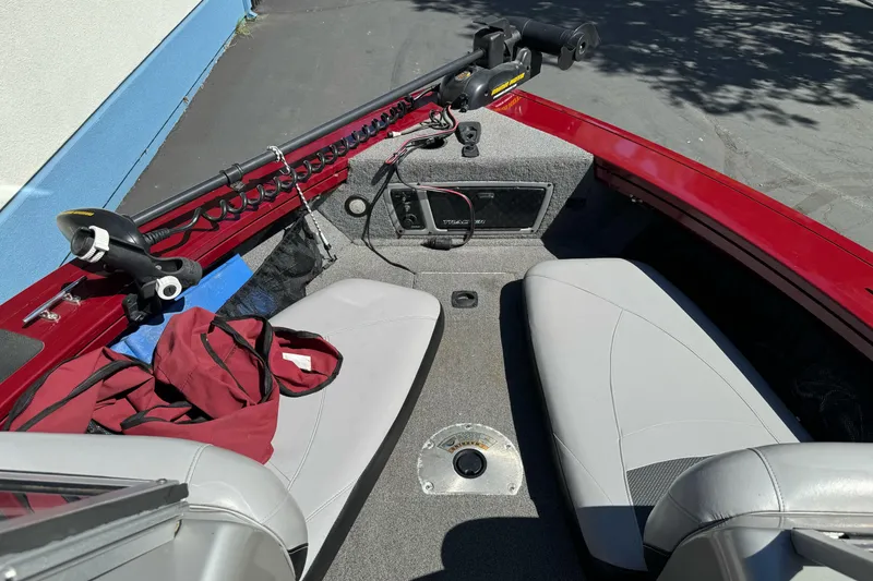 Slide: The Image of 2015 Tracker Targa V-18 Combo boat interior with seats and fishing equipment. - 15