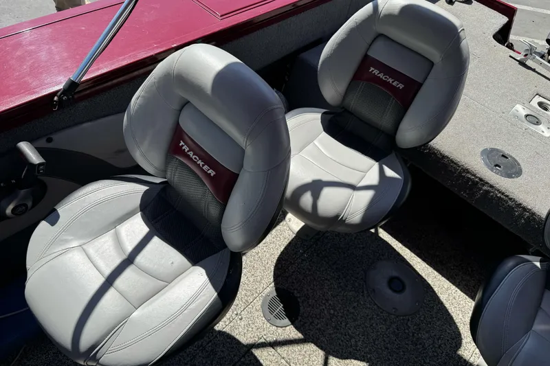 Slide: The Image of 2015 Tracker Targa V-18 Combo boat interior with gray seats and maroon accents. - 18