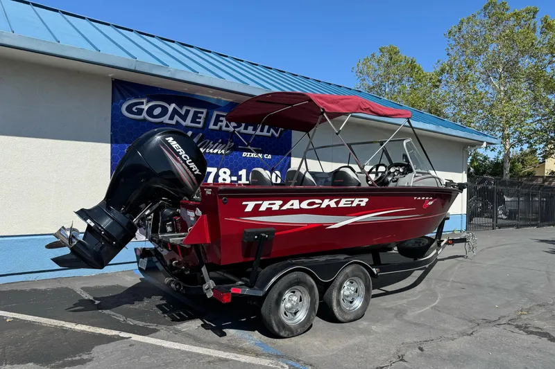 Slide: The Image of 2015 Tracker Targa V-18 Combo boat with Mercury engine, parked outdoors. - 3