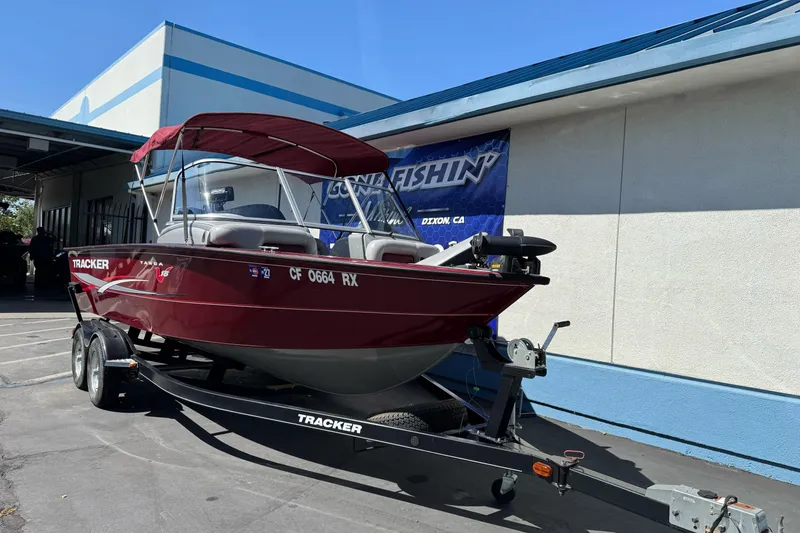 Slide: The Image of 2015 Tracker Targa V-18 Combo boat on trailer, parked outside a building. - 7