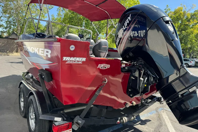 Slide: The Image of 2015 Tracker Targa V-18 Combo boat with Mercury engine, parked outdoors. - 9