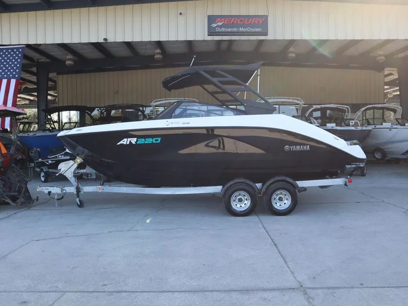The Image of 2025 Yamaha AR220 boat on trailer in showroom. - 1