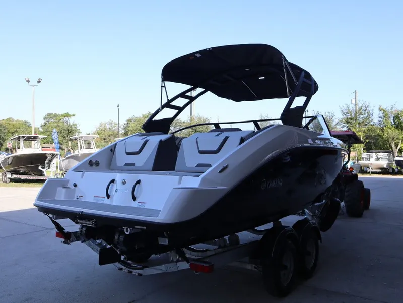 Slide: The Image of 2025 Yamaha AR220 boat on trailer outdoors. - 18