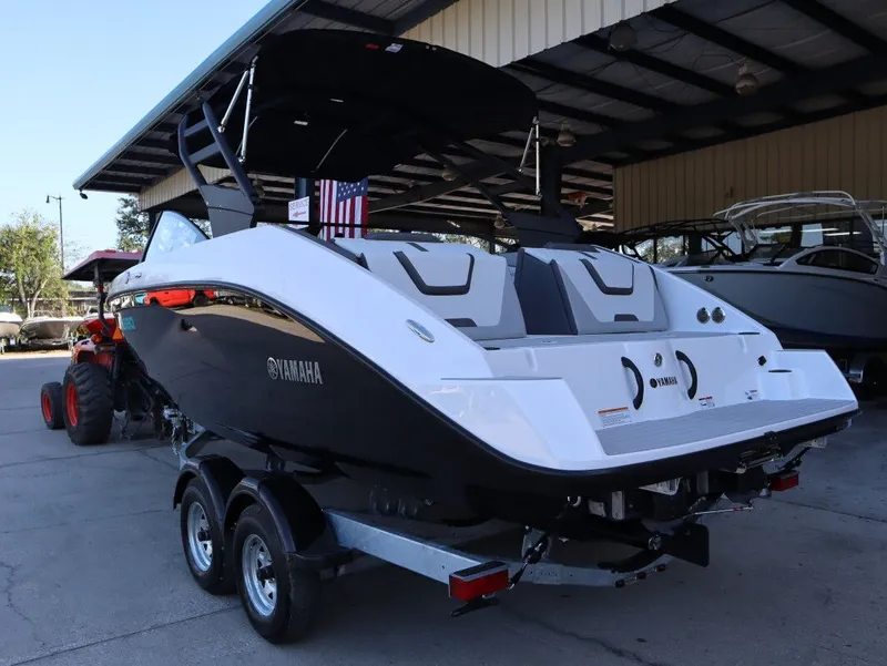 Slide: The Image of 2025 Yamaha AR220 boat on trailer in warehouse. - 20