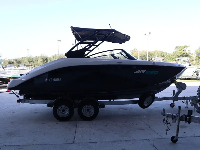 Slide: The Image of 2025 Yamaha AR220 boat parked on trailer outdoors. - 3